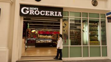A grocery store named Sam's Grocery with a clear entrance and a visible display of products inside.