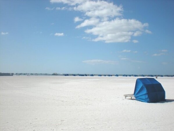 A large, open, flat area with a clear sky and a few clouds.