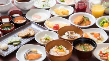 A variety of dishes including sushi, rice bowls, and soup, arranged on a table.