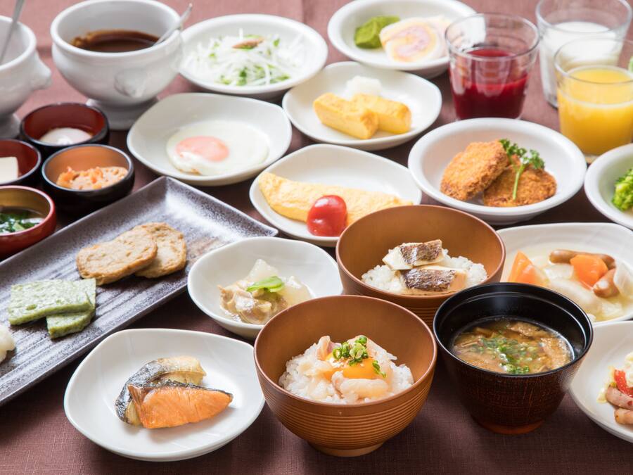 A variety of dishes including sushi, rice bowls, and soup, arranged on a table.