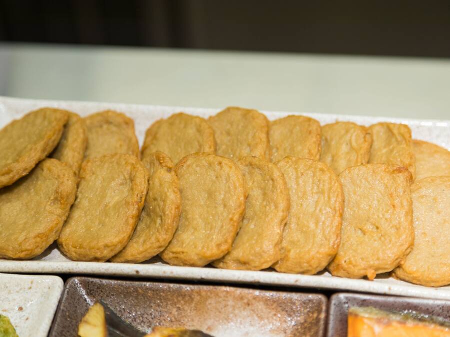 A tray of golden-brown pastries arranged neatly on a white plate.