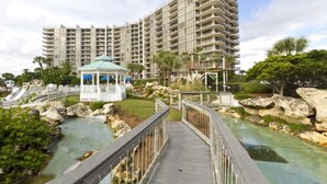 A resort with a large building, a gazebo, and a water feature.