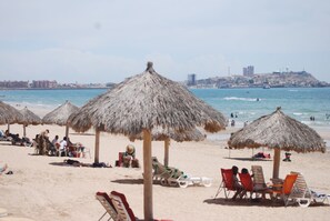 On the beach, sun loungers, beach towels
