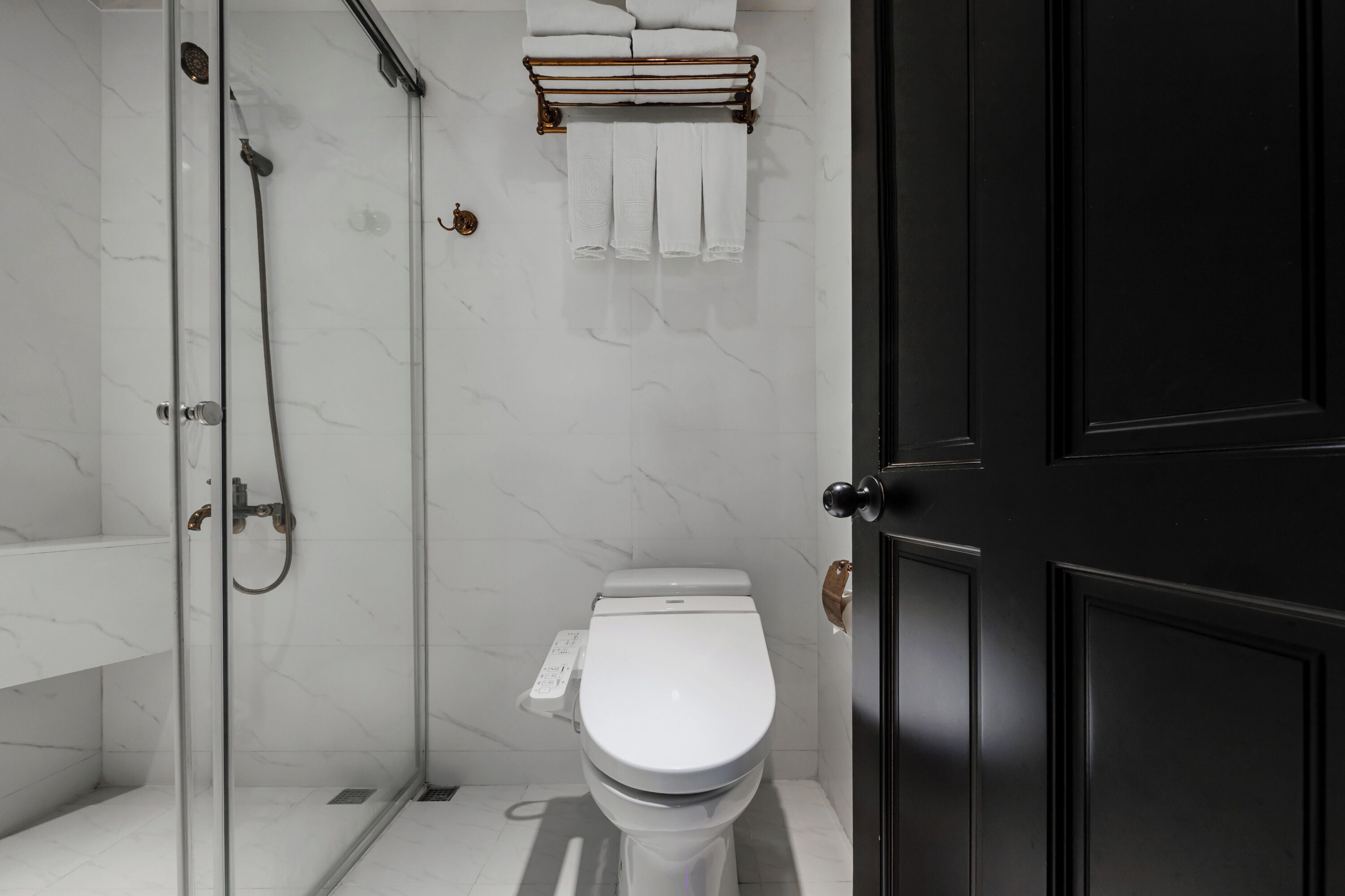 deluxe quadruple room | bathroom | shower, rainfall showerhead, hair dryer, towels