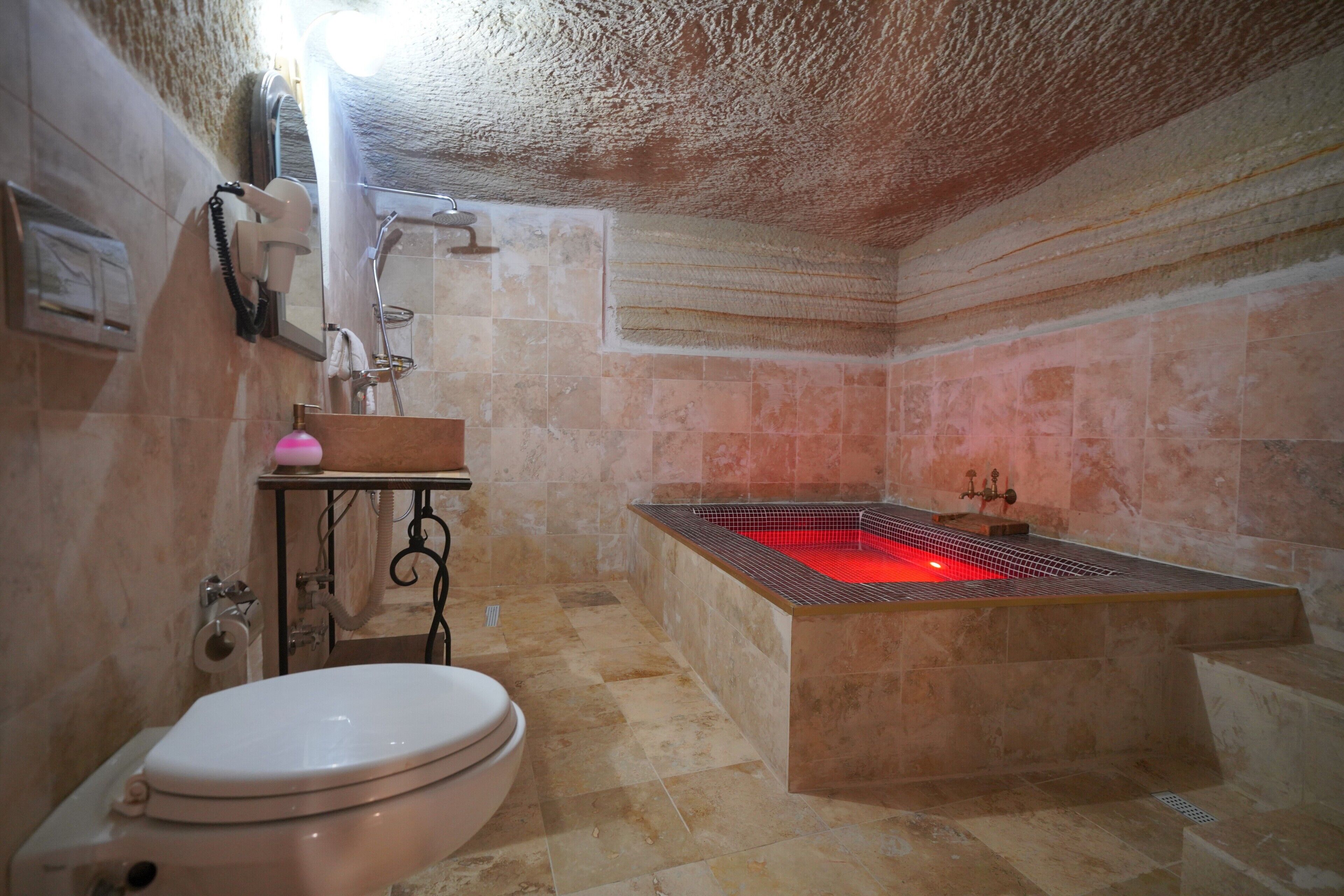 A bathroom with a bathtub, toilet, and sink.