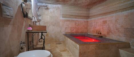 A bathroom with a bathtub, toilet, and sink.