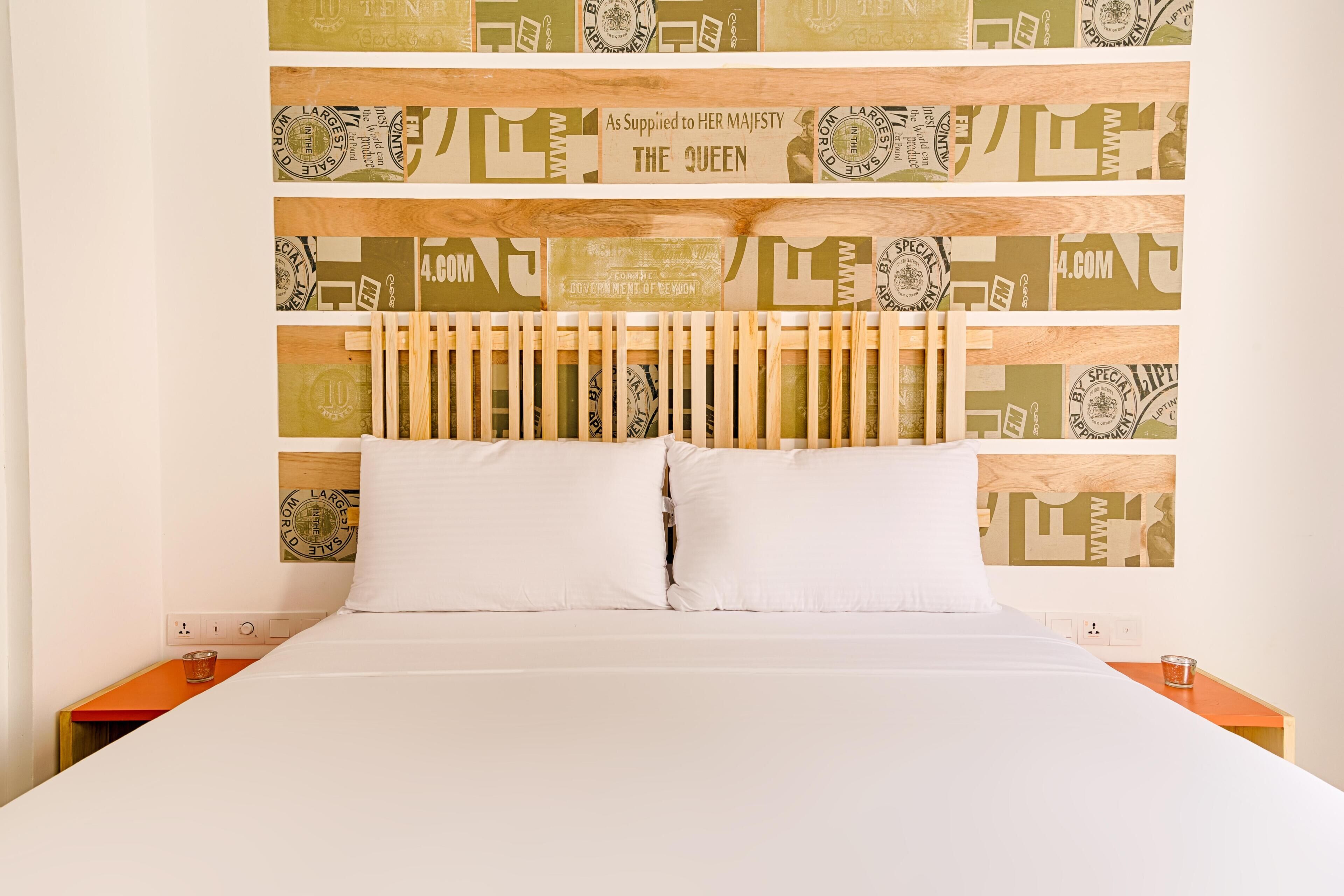 A bed with a headboard featuring a patterned design.