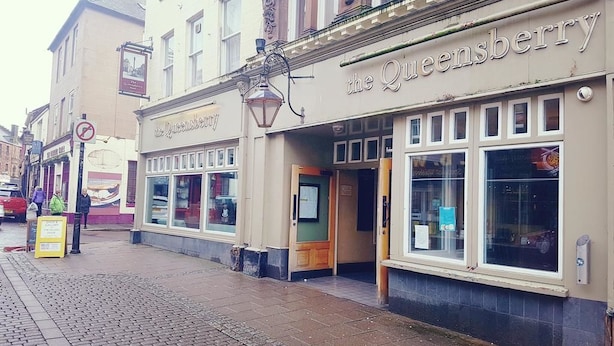 A building with a sign reading "the Queensberry."