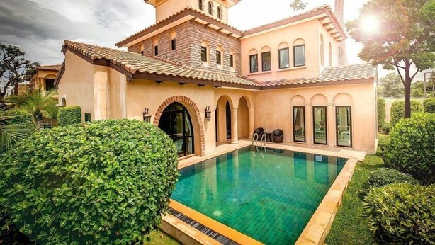A large house with a swimming pool, arched doorways, and a tower-like structure. - Estella Pool Villas Pattaya (Sattahip)