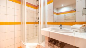 A bathroom with a shower, sink, and mirror. - Apartmany Engadin (Bozi Dar)