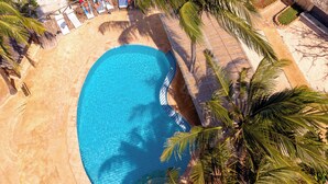 An aerial view of a resort with a swimming pool, beach, and palm trees. - Tanzanite Beach Resort (Nungwi)