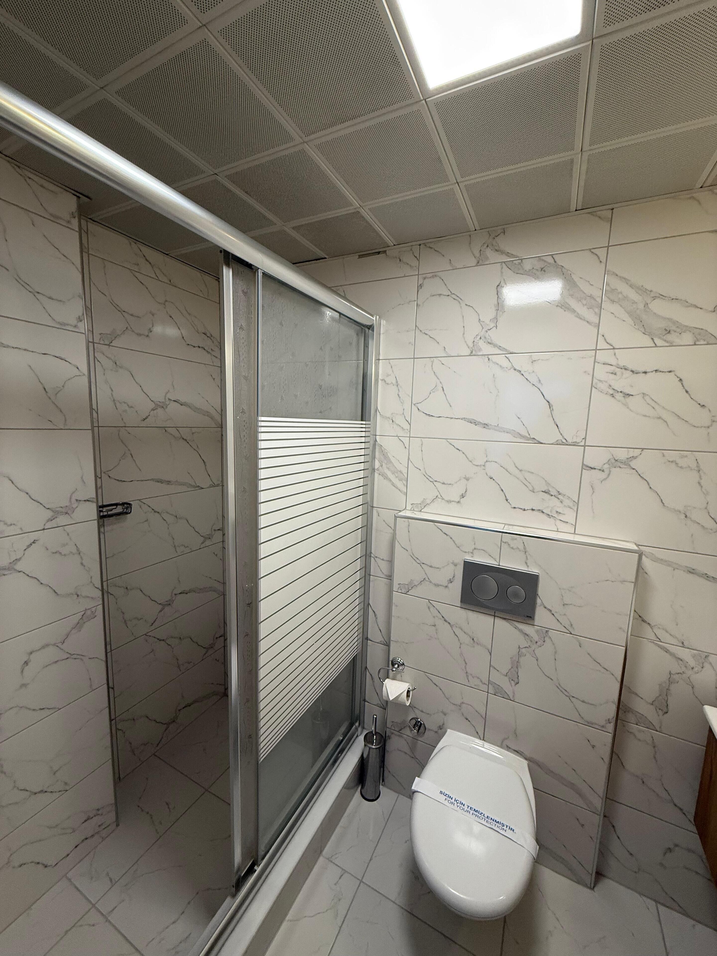 family triple room | bathroom | shower, free toiletries, hair dryer, slippers