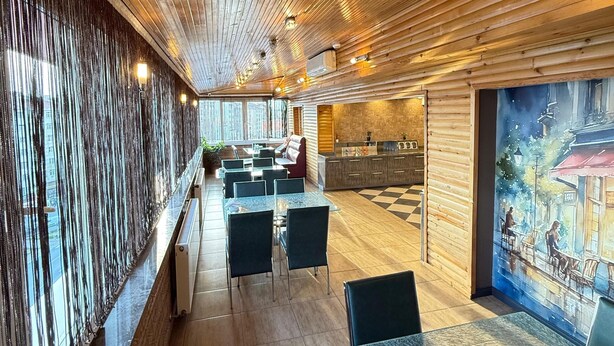 A restaurant with wooden ceiling, glass tables, and chairs. - Buyuk Hotel (Kayseri)