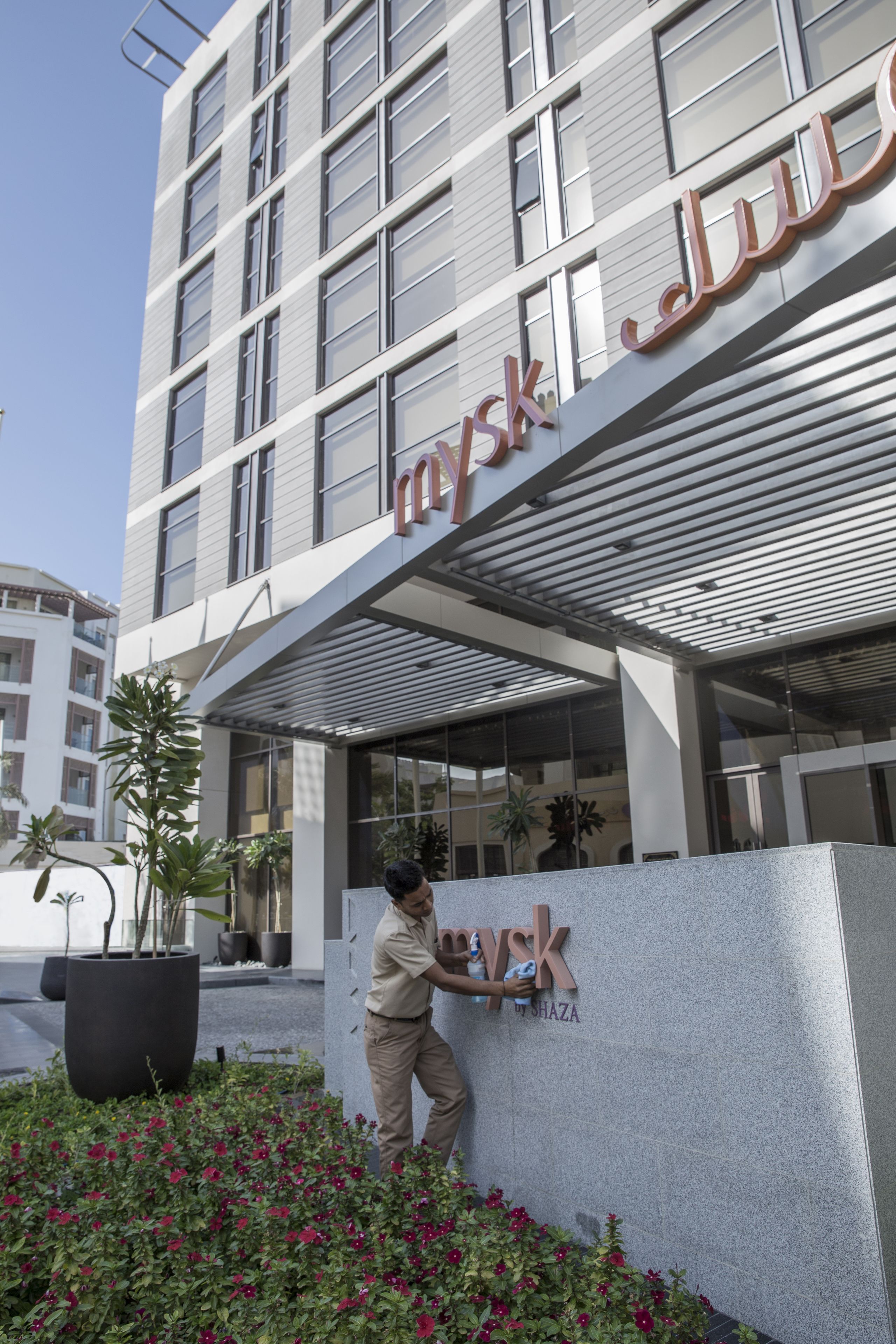 A modern building with a sign reading "mysk" and "WISHAZA".