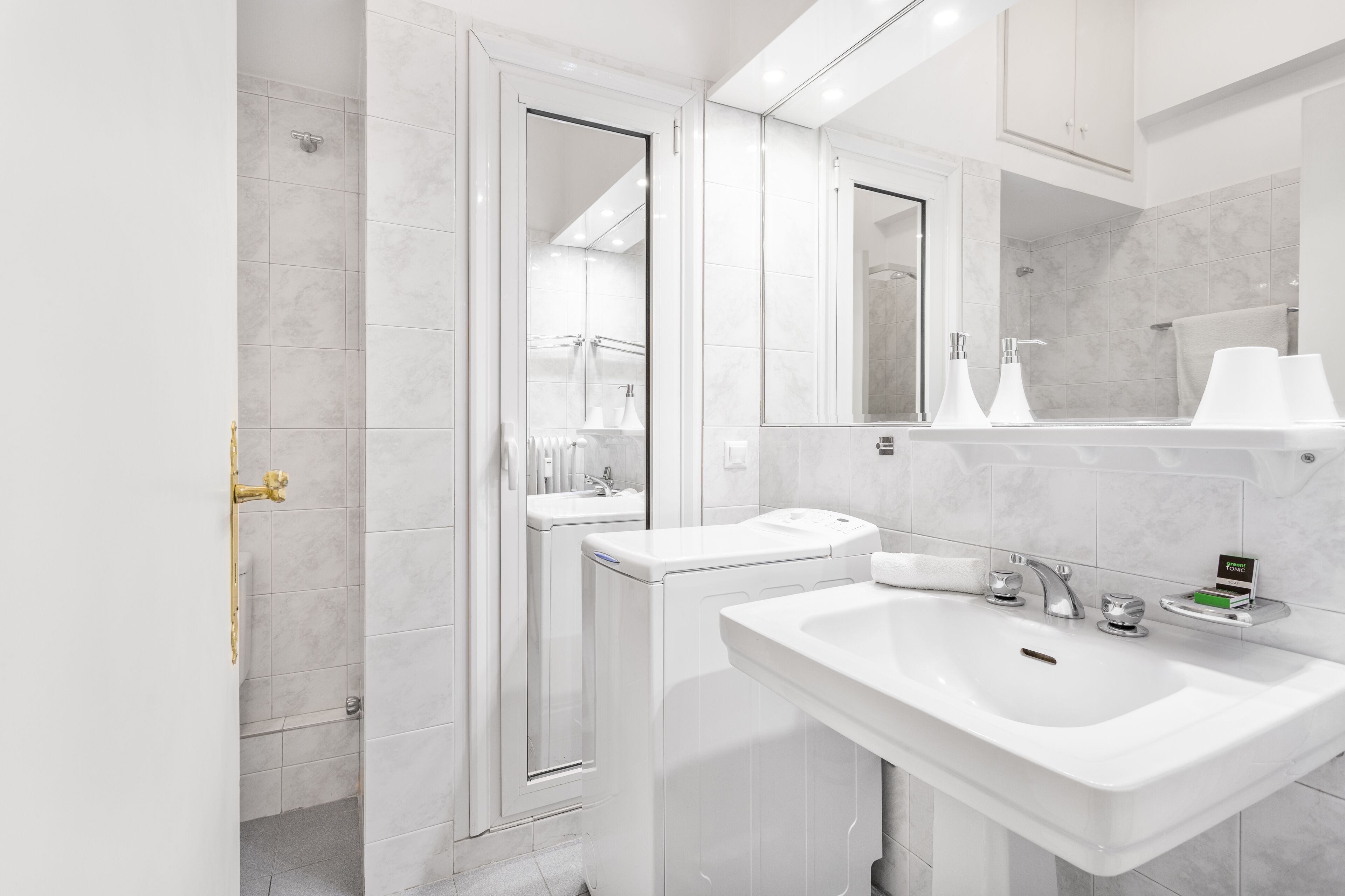 A modern bathroom with a walk-in shower, a sink, and a toilet.