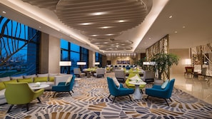 A hotel lobby with seating areas, a bar, and large windows. - Holiday Inn Suzhou Taihu Lake by IHG (Suzhou)