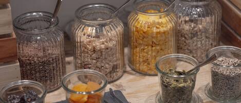 Various glass jars containing different food items on a wooden surface.