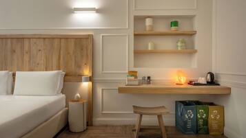 A hotel room with a wooden headboard, a bedside table with a lamp, a desk with a shelf, and a chair.