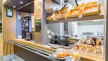 A breakfast buffet with various food items and beverages.