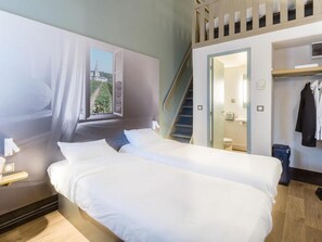 A hotel room with two beds, a window with a view, a staircase, and a coat rack. - B&B Hotel Tours Nord 1 Val De Loire (Tours)