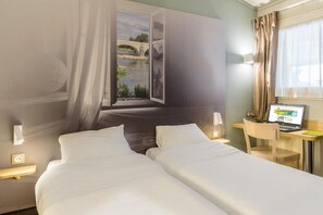 A hotel room with two beds, a desk with a laptop, a window with a view of a bridge, and a curtain. - B&B Hotel Tours Nord 1 Val De Loire (Tours)