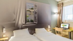 A hotel room with two beds, a desk with a laptop, a window with a view of a bridge, and a curtain. - B&B Hotel Tours Nord 1 Val De Loire (Tours)