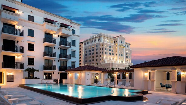 A hotel with a pool area, multiple balconies, and a well-lit facade. - Aloft by Marriott Coral Gables (Coral Gables)