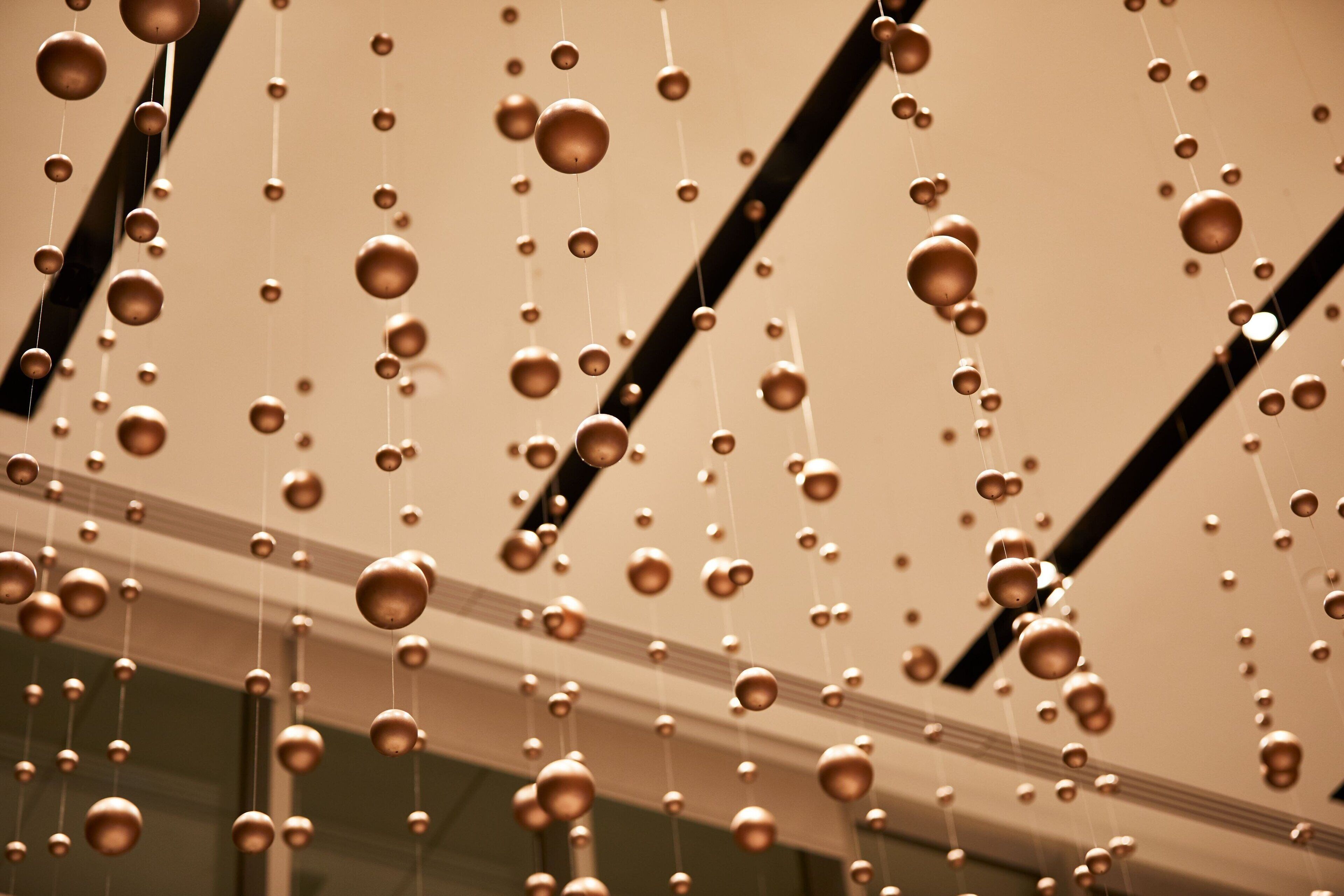 A ceiling with hanging spherical decorations.