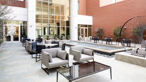 An outdoor patio area with seating and a water feature.