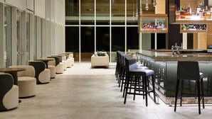 A modern bar area with seating and a bar counter.