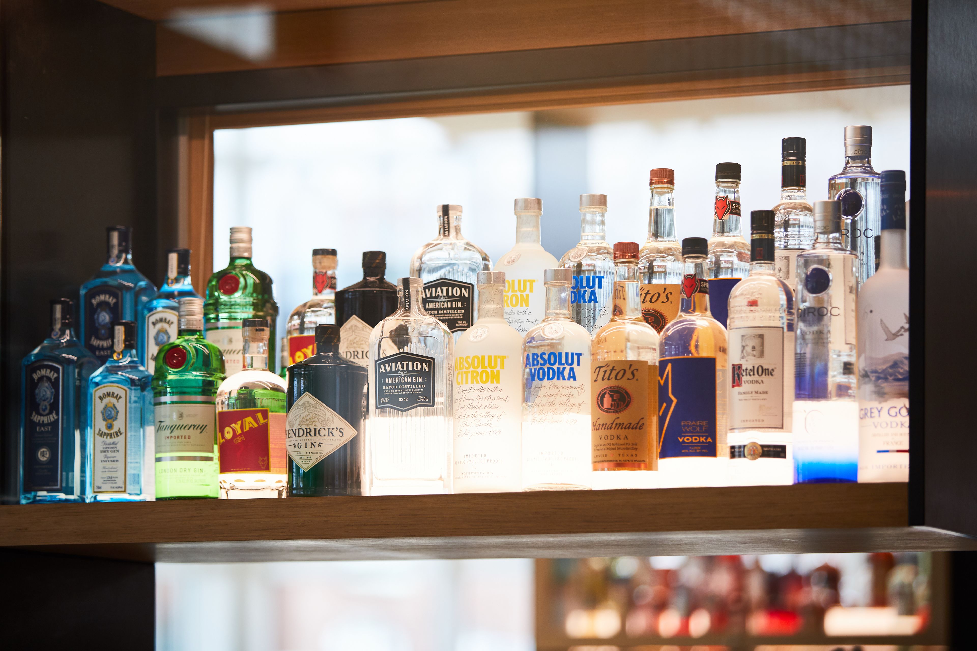 A variety of alcohol bottles displayed on a shelf.