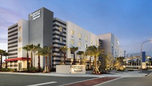 A Fairfield Inn & Suites Marriott hotel with a modern design, featuring a prominent sign, multiple floors, and a landscaped entrance with palm trees. - Fairfield Inn & Suites by Marriott Daytona Beach Speedway/Airport (Daytona Beach)