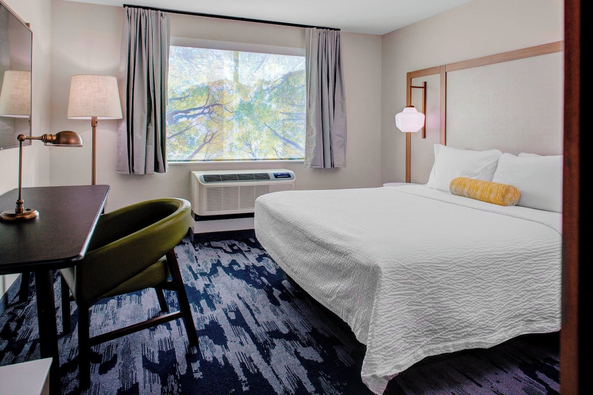 Premium bedding, desk, laptop workspace, blackout curtains