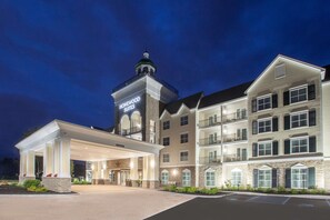 A hotel with a prominent tower, a covered entrance, and multiple balconies. - Homewood Suites by Hilton Saratoga Springs (Saratoga Springs)
