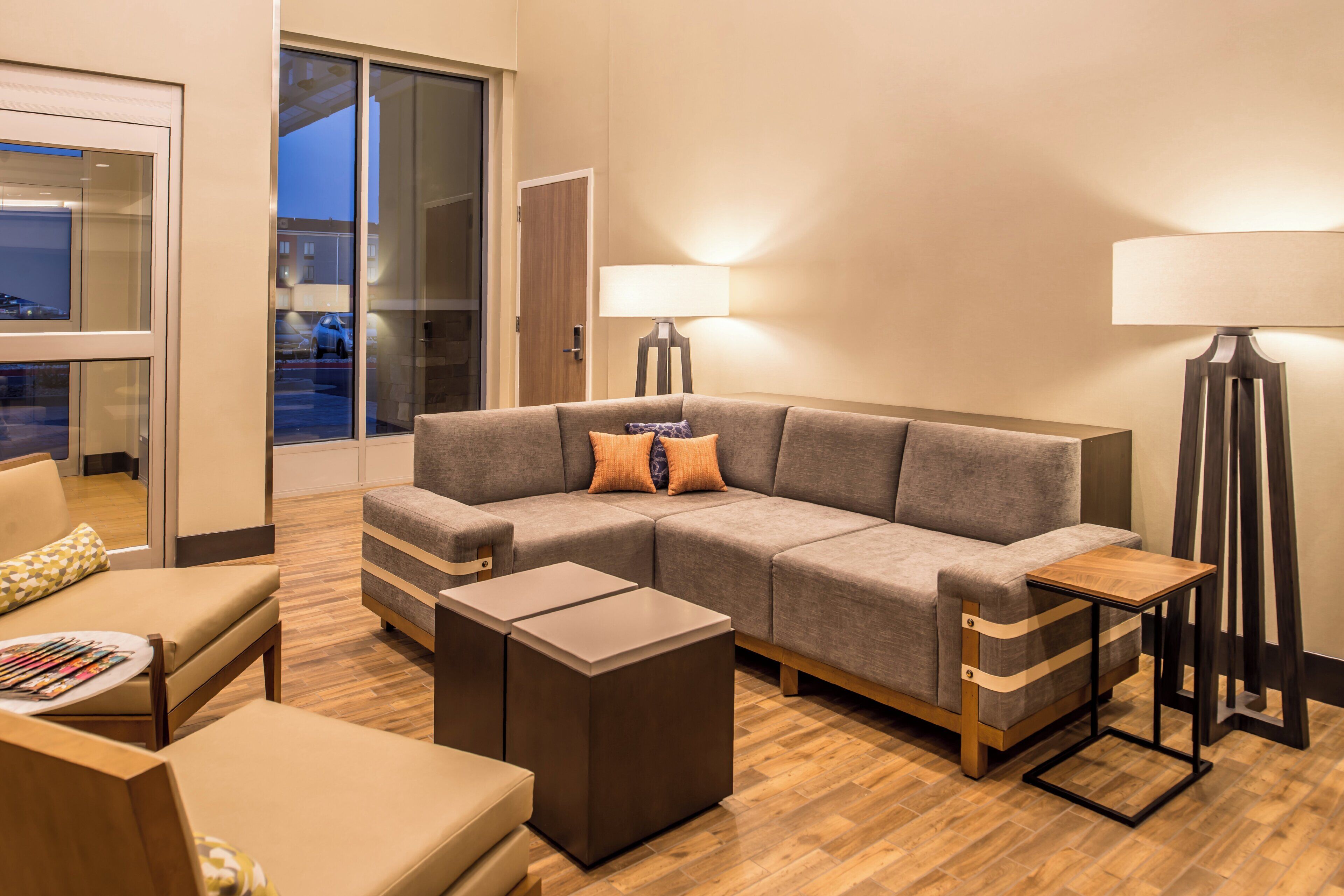 A modern living room with a sectional sofa, two side tables, and a coffee table.