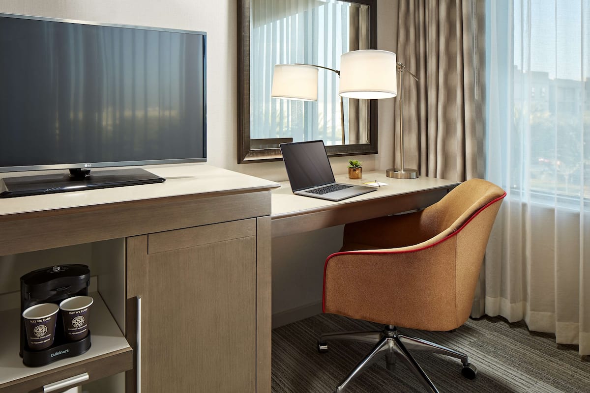 Premium bedding, desk, laptop workspace, blackout drapes
