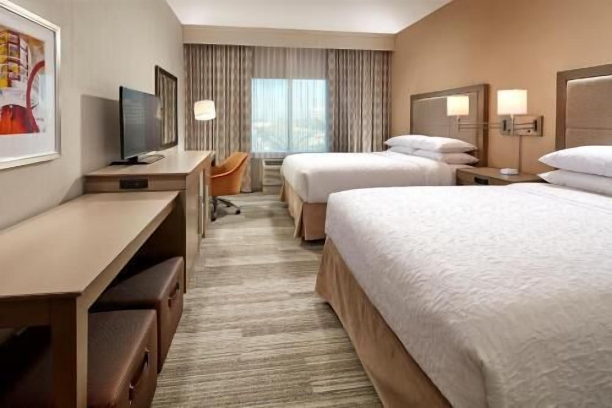 Premium bedding, desk, laptop workspace, blackout curtains