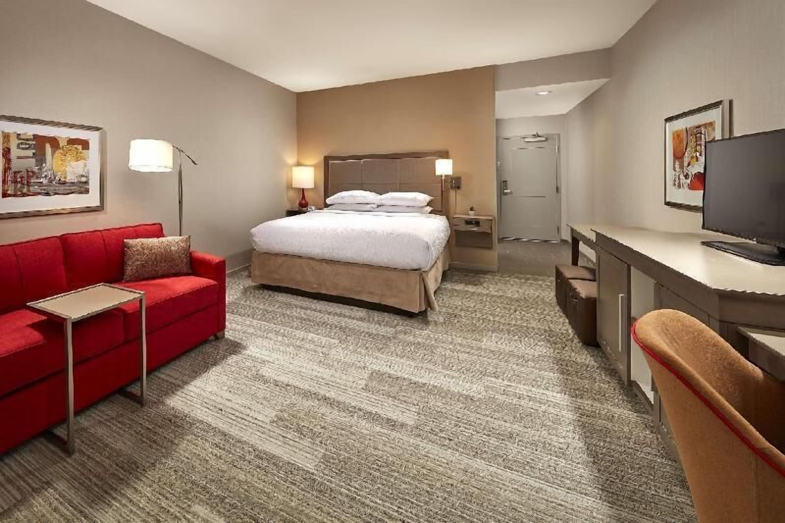 Premium bedding, desk, laptop workspace, blackout curtains