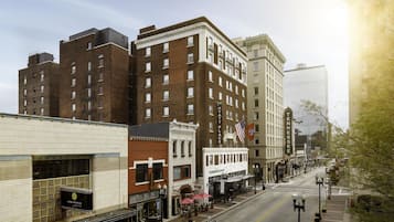 A street view with a mix of historic and modern buildings, including a Starbucks and a building with a sign that reads "Tennessee".