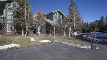 A residential area with houses, trees, and a clear sky.
