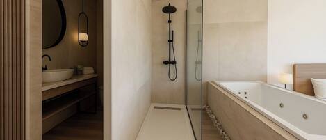 A modern bathroom with a walk-in shower, a freestanding bathtub, and a vanity with a large mirror.