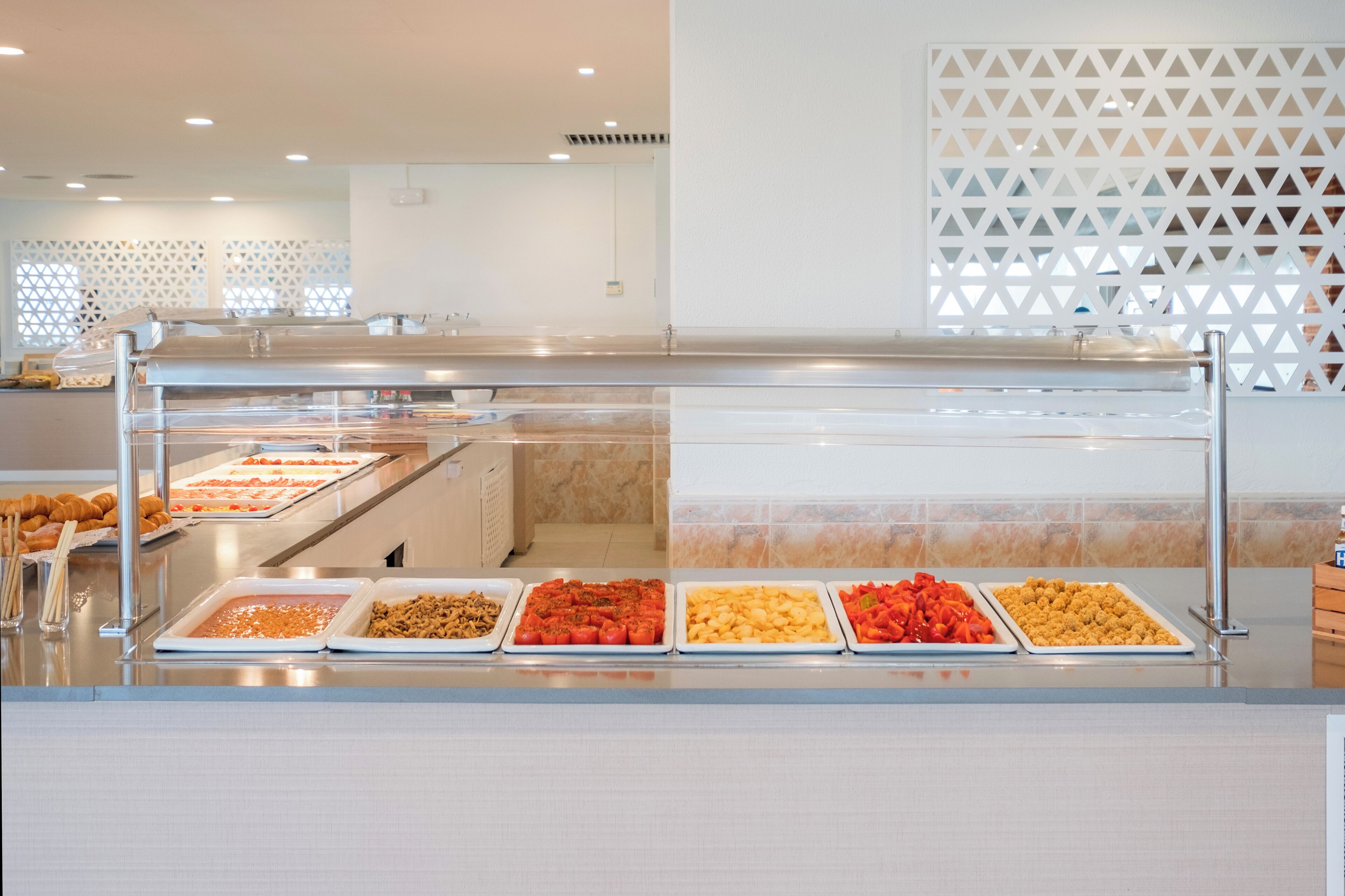 A buffet area with various food trays.