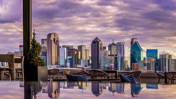A rooftop lounge with a city skyline view, including modern high-rise buildings and a clear sky. - Canopy by Hilton Dallas Uptown (Dallas)