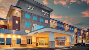 Een Fairfield Inn & Suites Marriott hotel met een modern design, met een gevel van natuursteen, meerdere balkons en een overdekte ingang.