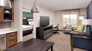 A hotel room with a bed, a desk, a TV, a chair, and a sofa. - Residence Inn by Marriott New Orleans Elmwood (New Orleans)