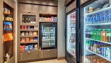 A refrigerated display case with various beverages and snacks.