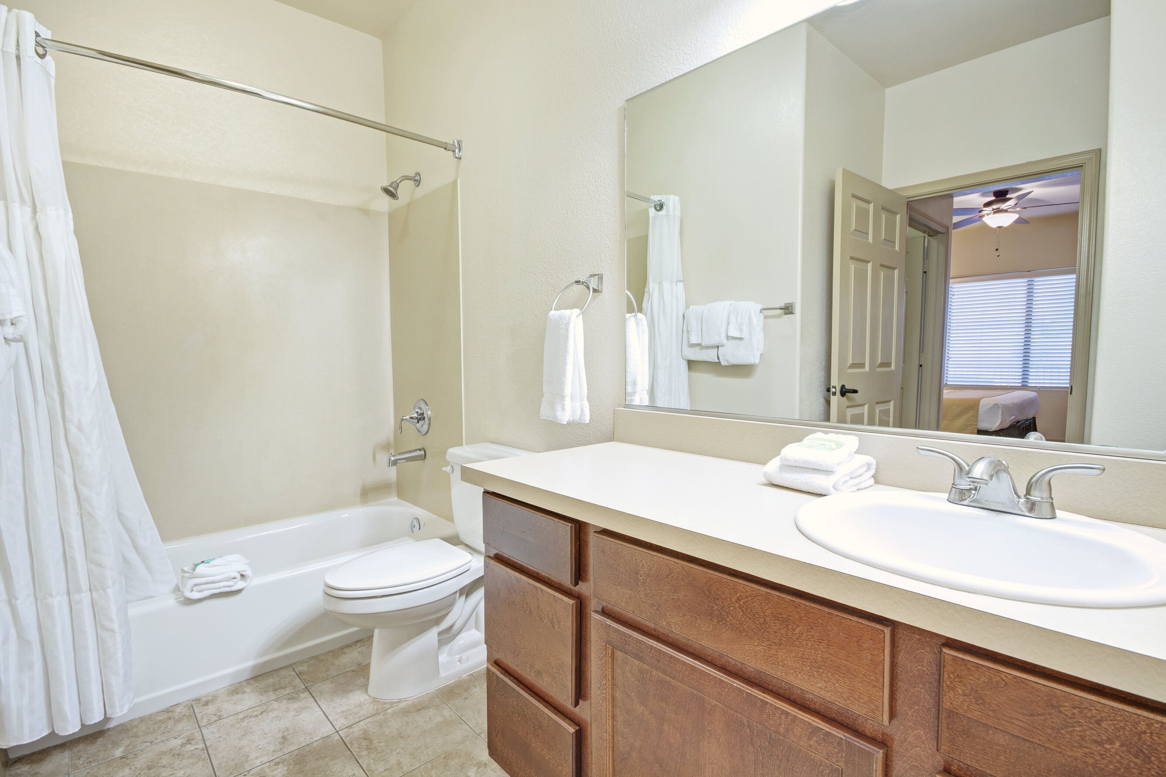 A bathroom with a bathtub, toilet, and sink.