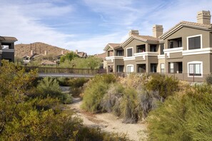 A residential area with modern houses, a dirt path, and a hilly landscape in the background. - WorldMark Phoenix - South Mountain Preserve (Phoenix)