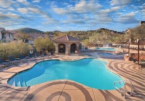 A swimming pool with lounge chairs and a small gazebo. - WorldMark Phoenix - South Mountain Preserve (Phoenix)