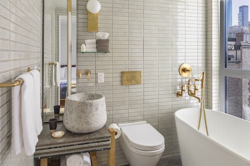 Executive Suite, Bathtub, City View | Bathroom | Shower, hair dryer, bathrobes, slippers